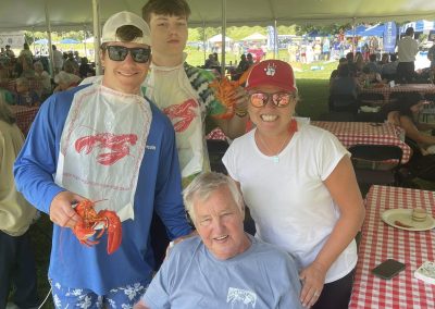 Ed Armstrong with family under the tent at Lobsterfest